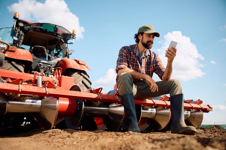 Farm worker using mobile phone in field