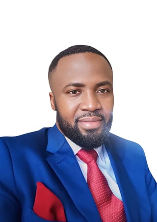 Professional headshot of a man in a blue suit and red patterned tie against a white background